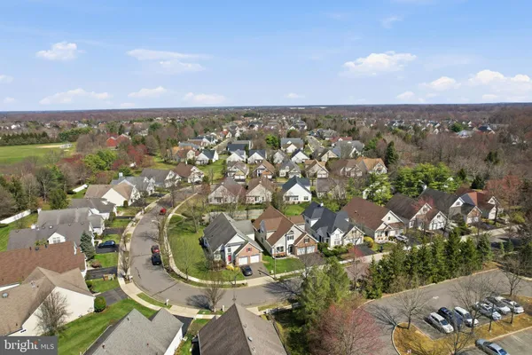 an aerial view of a houses with a lake