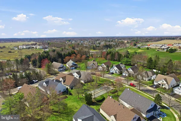 an aerial view of a city with lots of residential buildings and mountain view in back