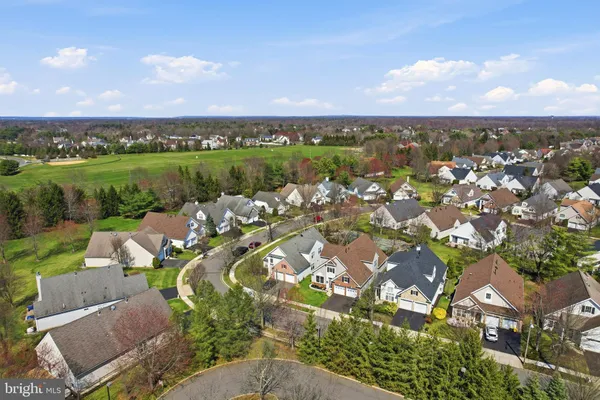 an aerial view of a city with lots of residential buildings lake and ocean view