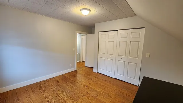 an empty room with wooden floor