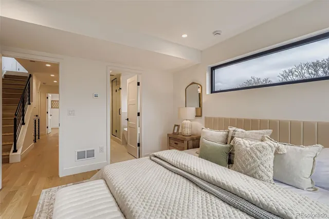 a bedroom with a bed and a couch