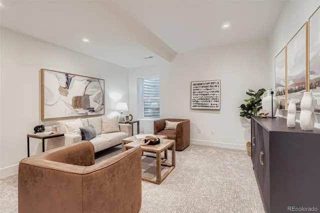 a living room with furniture and a potted plant