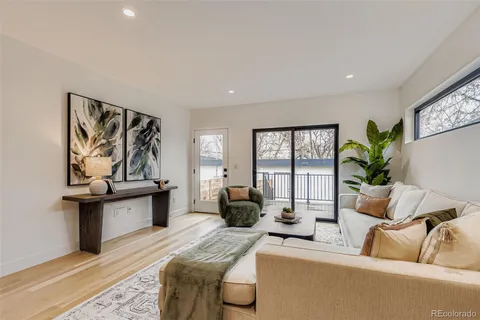 a living room with furniture a couch and a potted plant