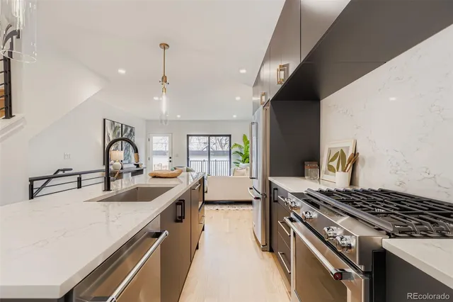 a kitchen with sink stove and refrigerator