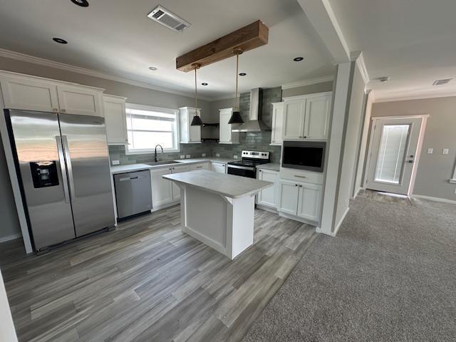 202 Skipjack Lane Freeport, FL 32439 - Photo 2 of 10 a kitchen with stainless steel appliances a refrigerator a sink a stove a microwave and wooden floors