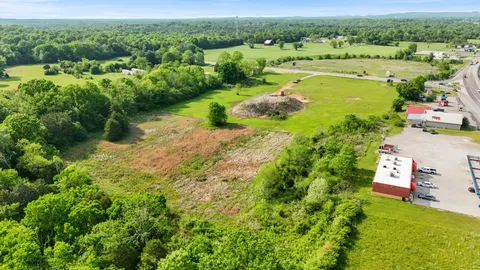 an aerial view of ocean with residential house lake and trees around