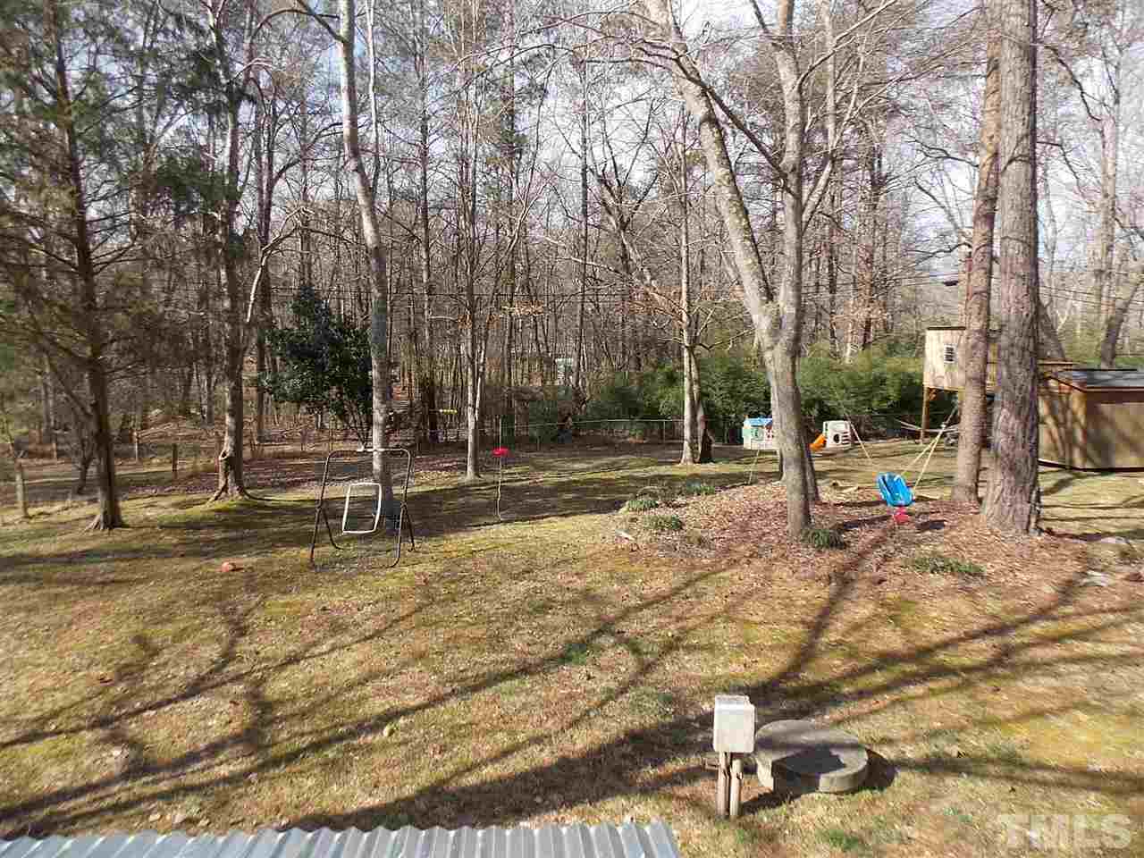 6735 Johnson Mill Road Durham, NC 27712 - Photo 2 of 18 a view of a park with swings and slides
