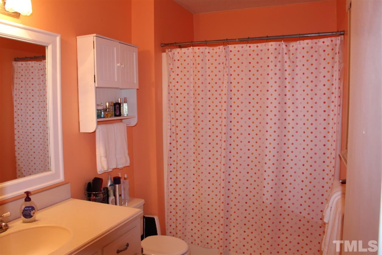 6735 Johnson Mill Road Durham, NC 27712 - Photo 15 of 18 a bathroom with a sink and a mirror