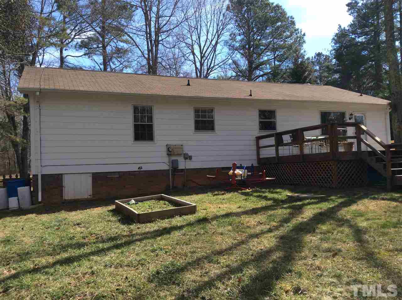 6735 Johnson Mill Road Durham, NC 27712 - Photo 16 of 18 a view of a house with a yard