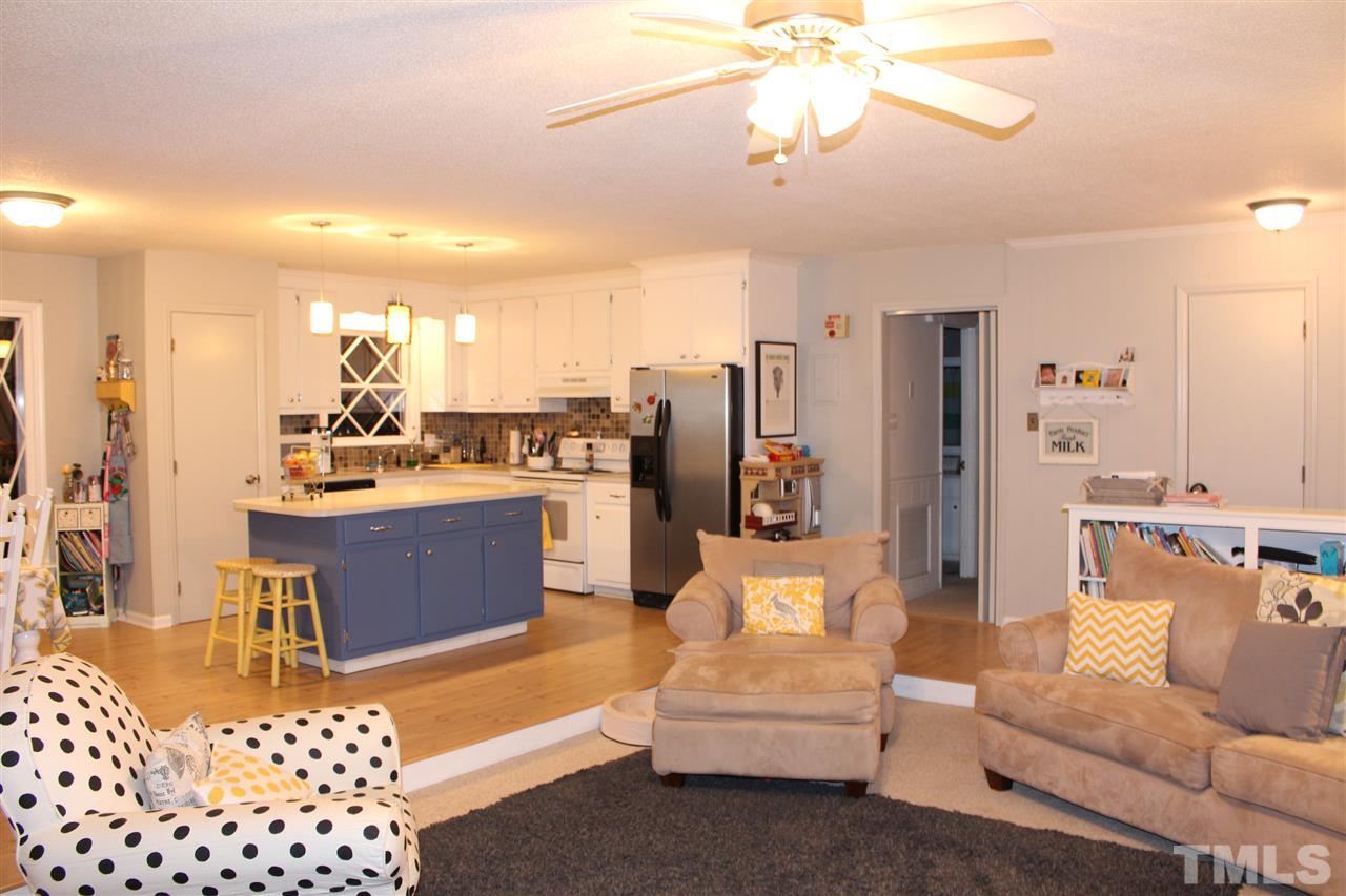 6735 Johnson Mill Road Durham, NC 27712 - Photo 3 of 18 a living room with furniture and a chandelier
