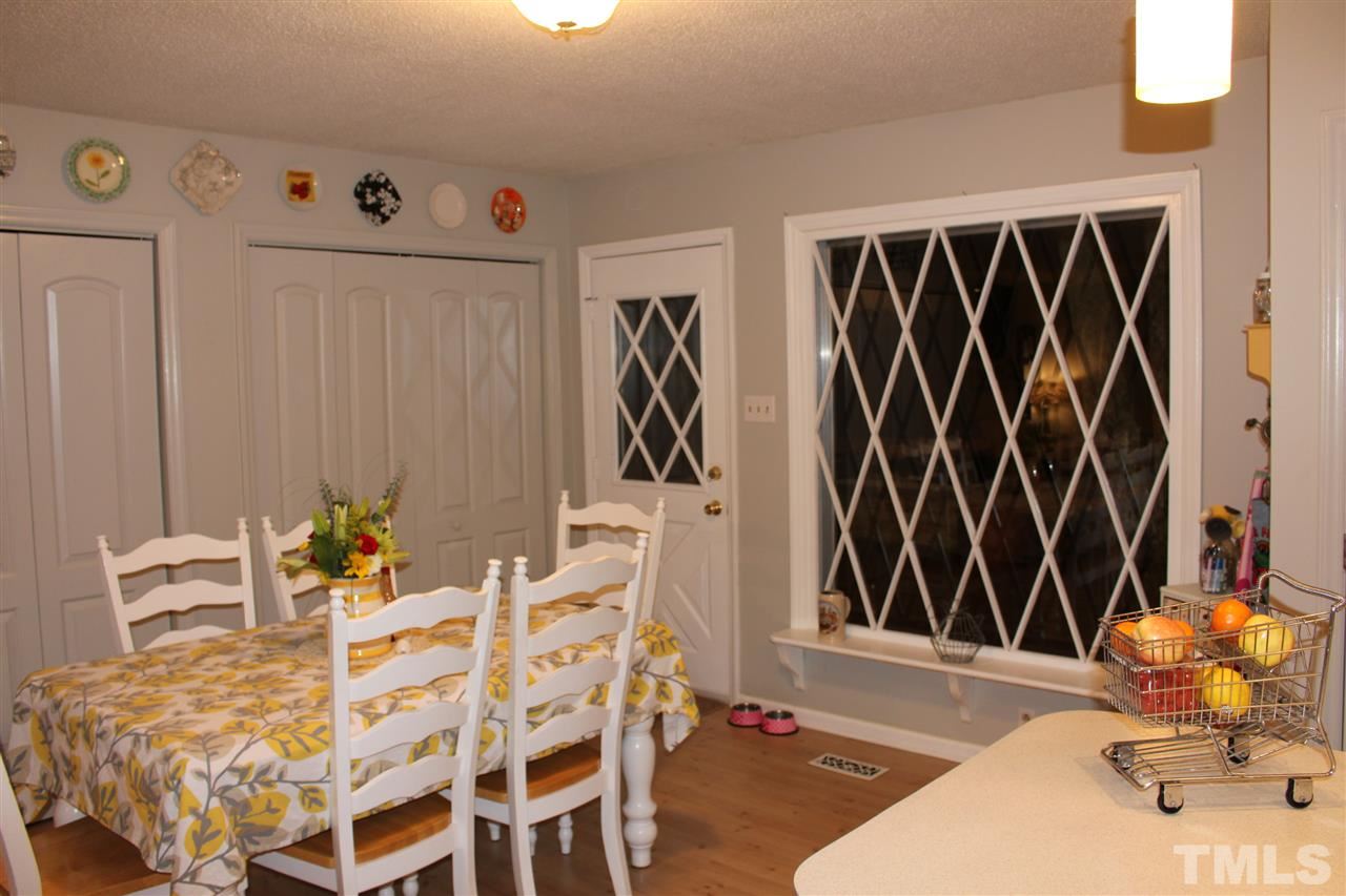 6735 Johnson Mill Road Durham, NC 27712 - Photo 6 of 18 a dining room with furniture and a window