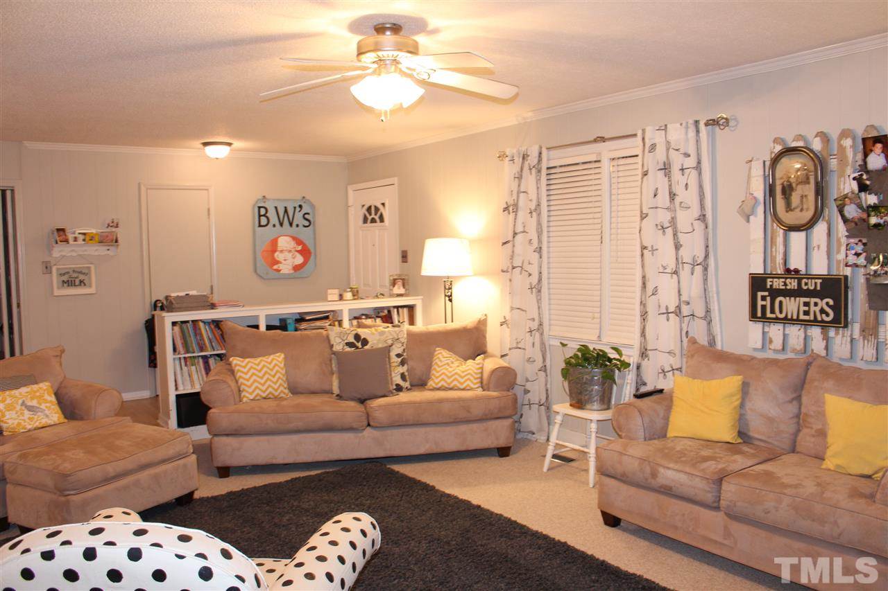 6735 Johnson Mill Road Durham, NC 27712 - Photo 8 of 18 a living room with furniture and a chandelier