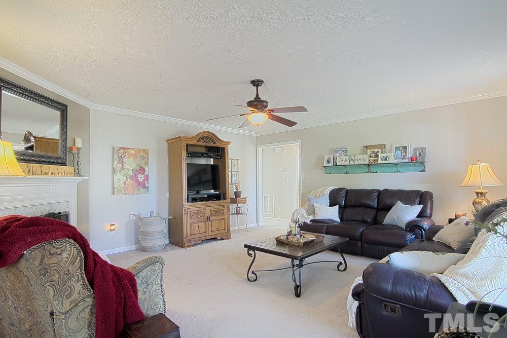 1409 Jenny Ridge Lane Willow Spring, NC 27592 - Photo 5 of 22 a living room with furniture and a flat screen tv