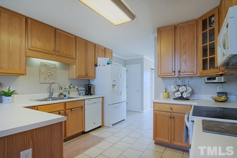1409 Jenny Ridge Lane Willow Spring, NC 27592 - Photo 10 of 22 a kitchen with a sink a stove and cabinets