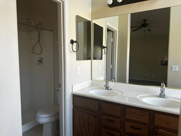 a bathroom with a bathtub sink vanity and mirror