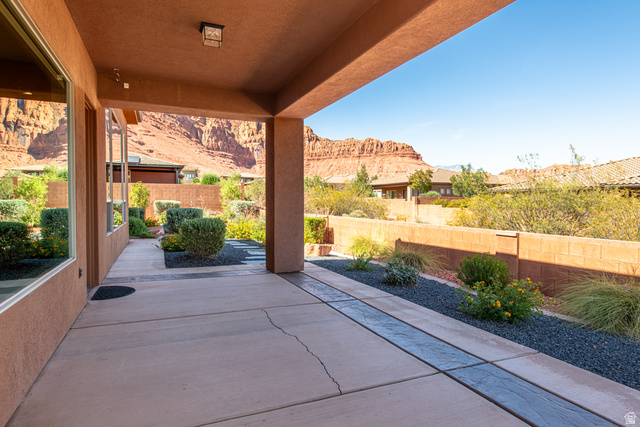 322 340 E Street Ivins, UT 84738 - Photo 52 of 61 Spacious covered patio featuring concrete flooring with decorative inlay, stucco exterior, built-in recessed lighting, and low-maintenance landscaping with dark aggregate