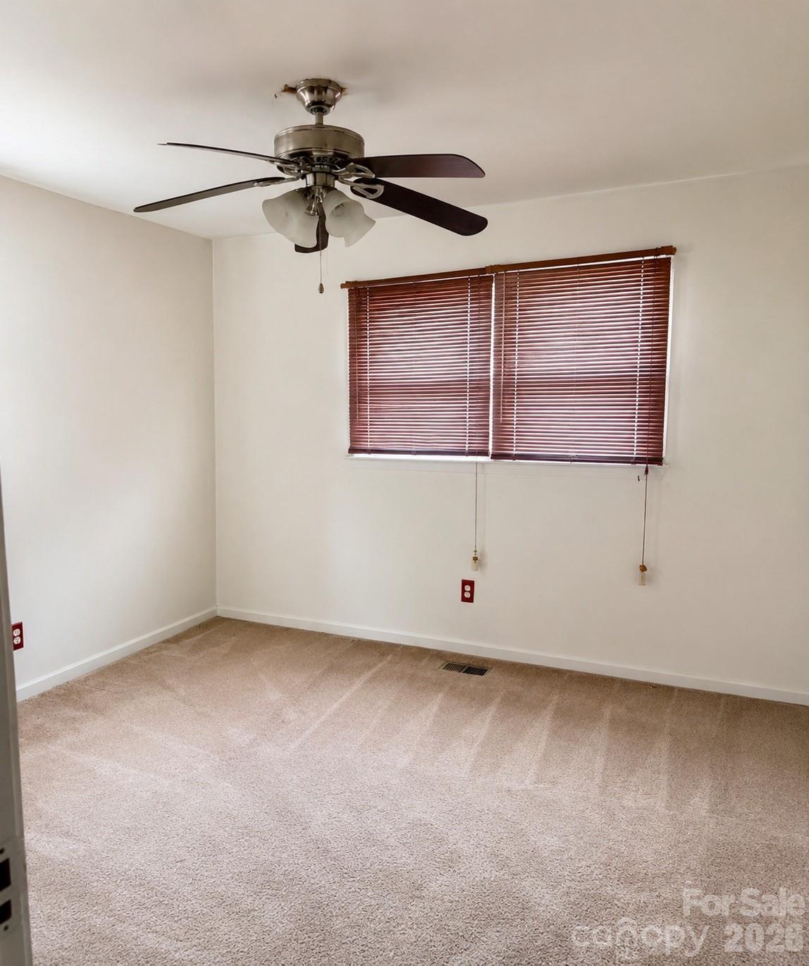 405 Isom Street Lancaster, SC 29720 - Photo 6 of 8 an empty room with windows and fan