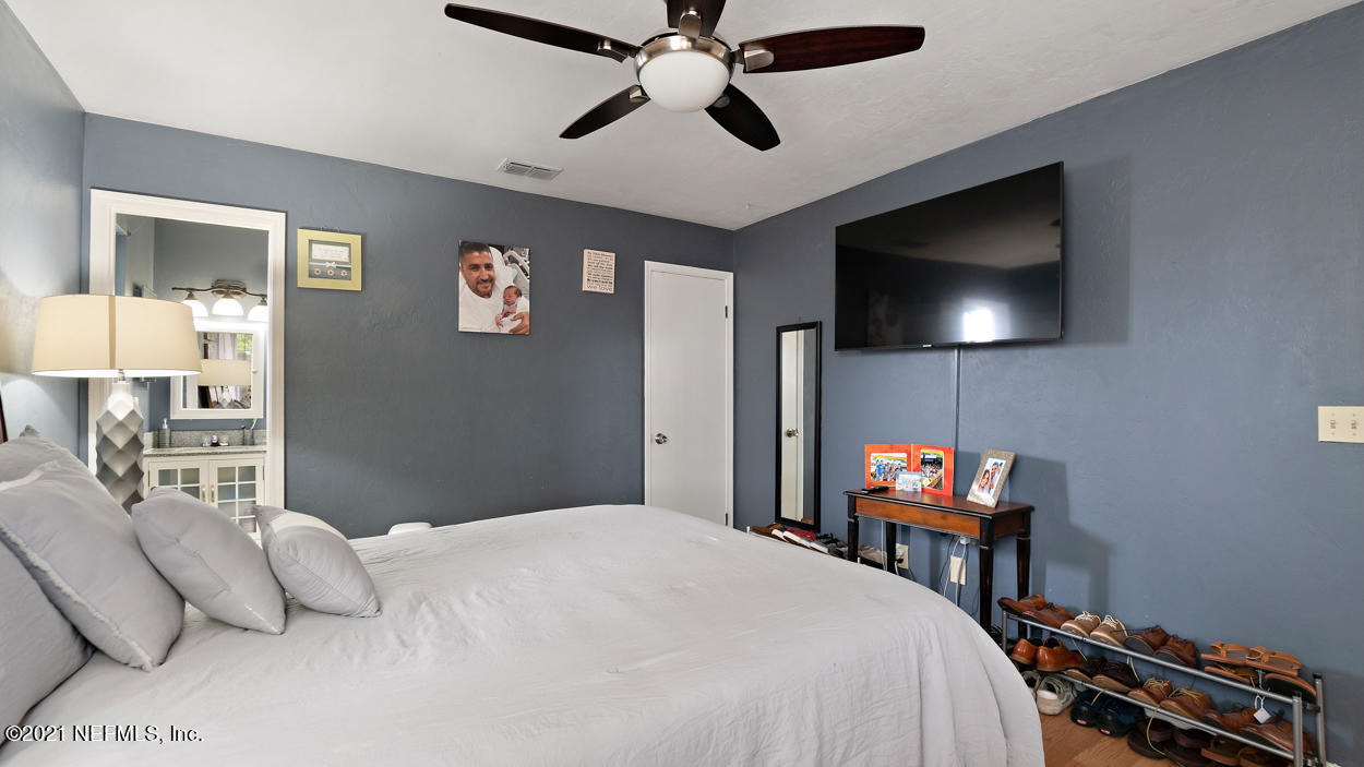 2360 Bitternut Way Jacksonville, FL 32246 - Photo 19 of 26 a bedroom with a bed and a flat screen tv