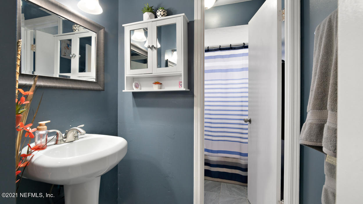 2360 Bitternut Way Jacksonville, FL 32246 - Photo 4 of 26 a bathroom with a sink and a mirror