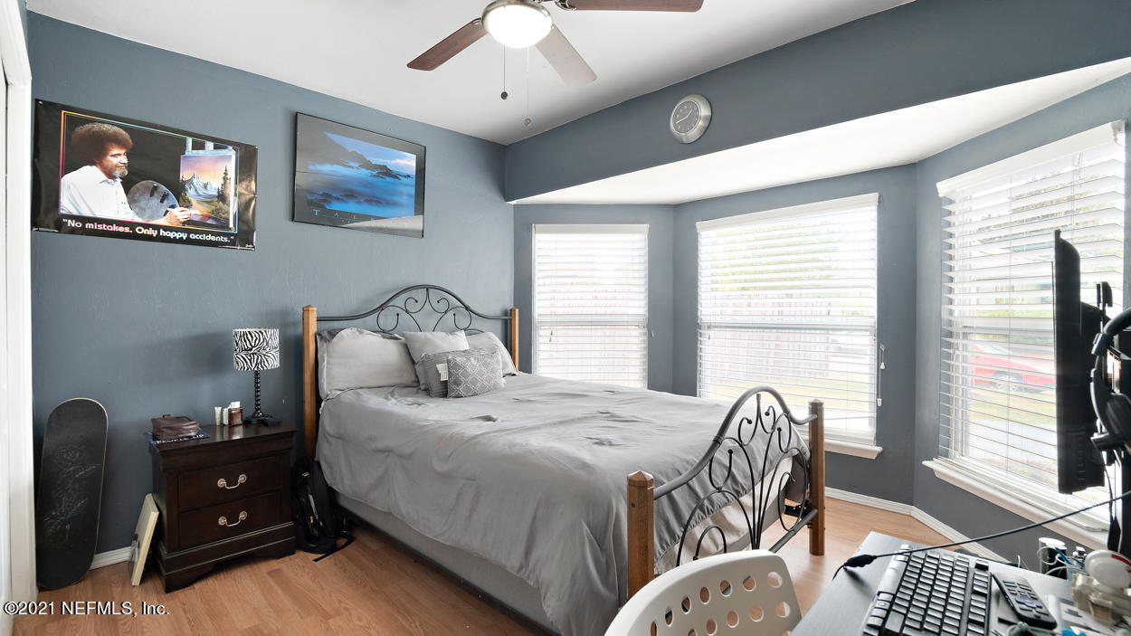 2360 Bitternut Way Jacksonville, FL 32246 - Photo 6 of 26 a bedroom with a bed and large windows