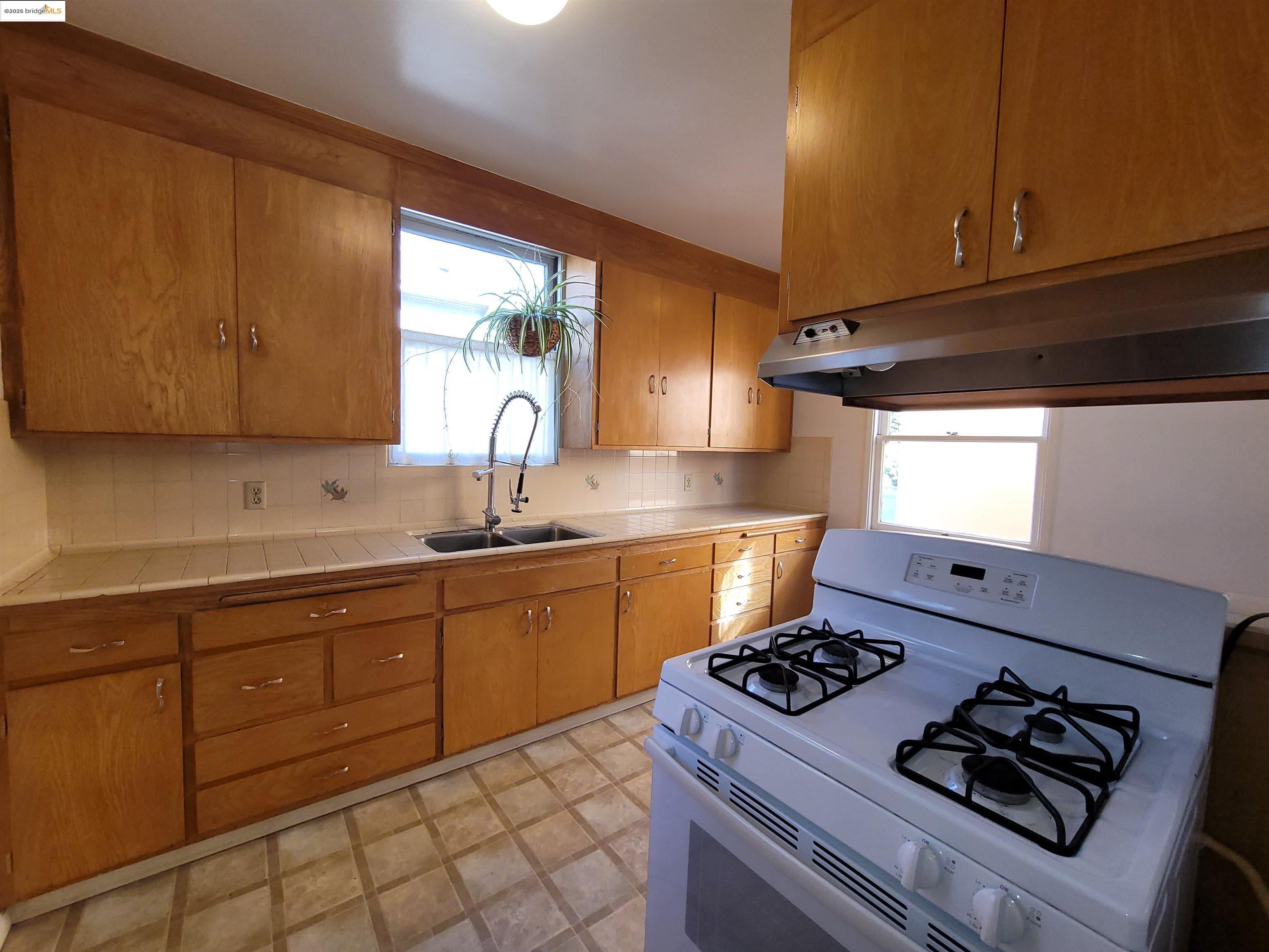 1901 Parker Street, Unit 3 Berkeley, CA 94704 - Photo 18 of 27 a kitchen with sink stove and cabinets