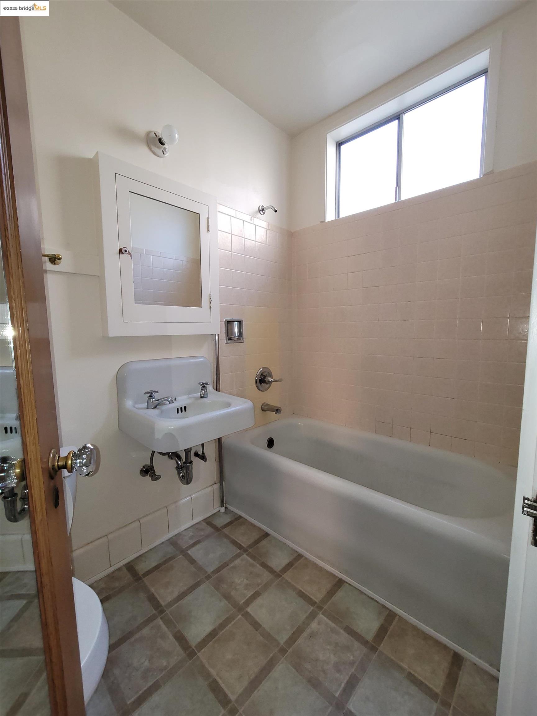 1901 Parker Street, Unit 3 Berkeley, CA 94704 - Photo 21 of 27 a bathroom with a sink a toilet and shower