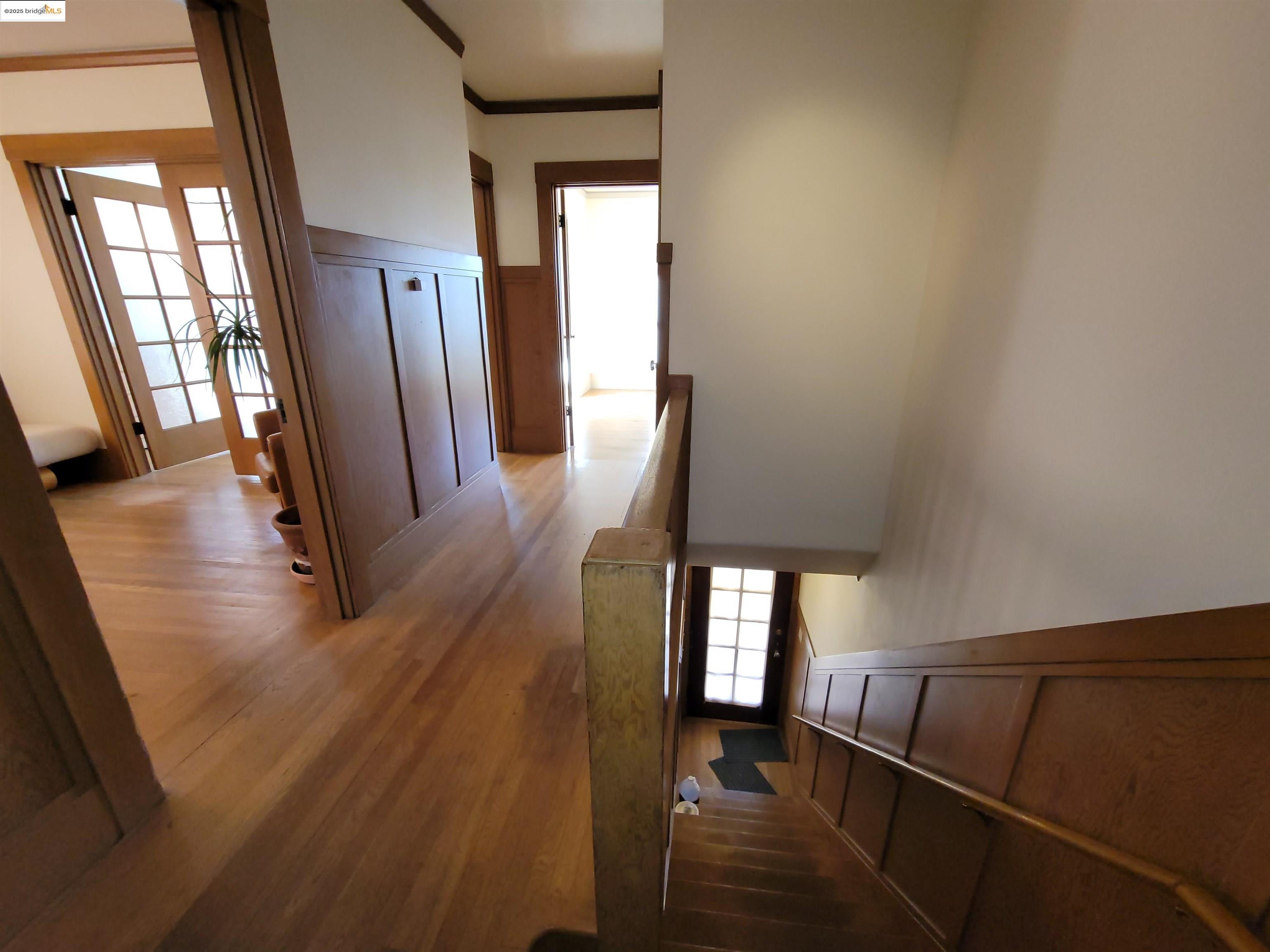 1901 Parker Street, Unit 3 Berkeley, CA 94704 - Photo 5 of 27 a view of a livingroom with wooden floor and stairs