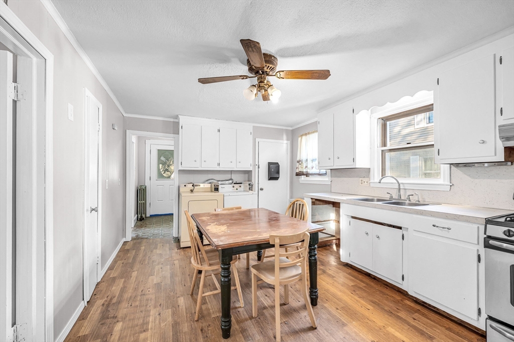 29 Wareham Street Springfield, MA 01108 - Photo 11 of 38 a kitchen with a dining table chairs cabinets a sink and a window