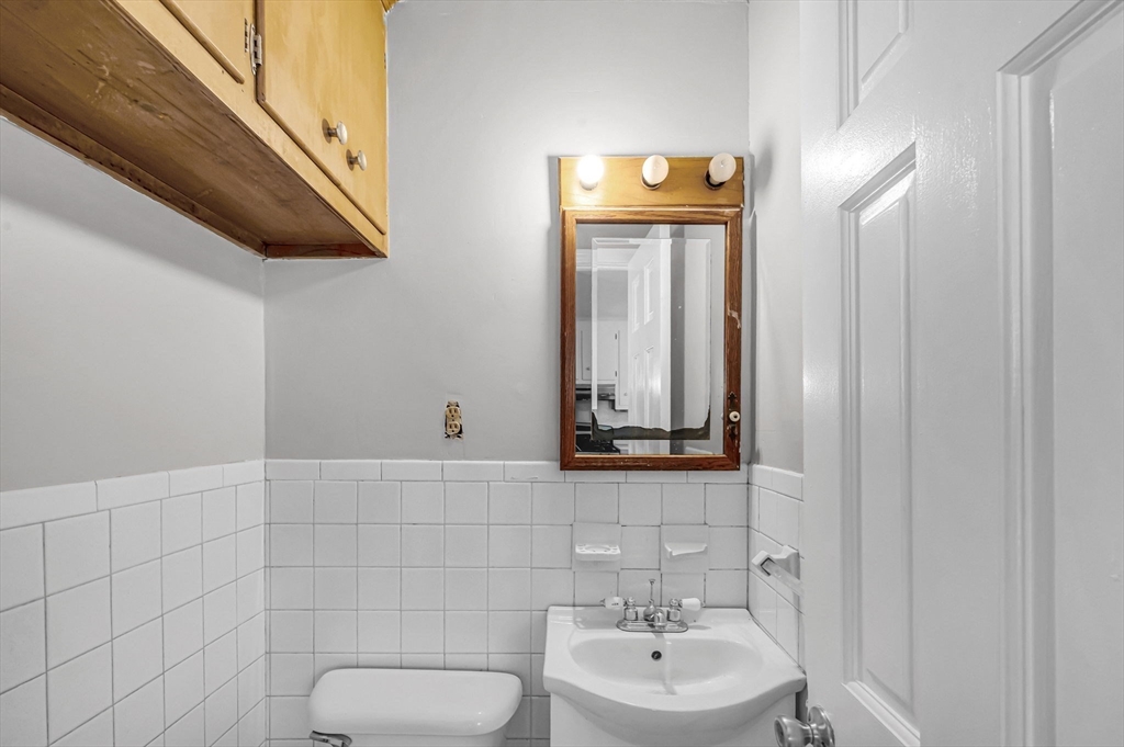 29 Wareham Street Springfield, MA 01108 - Photo 14 of 38 a bathroom with a toilet sink and mirror