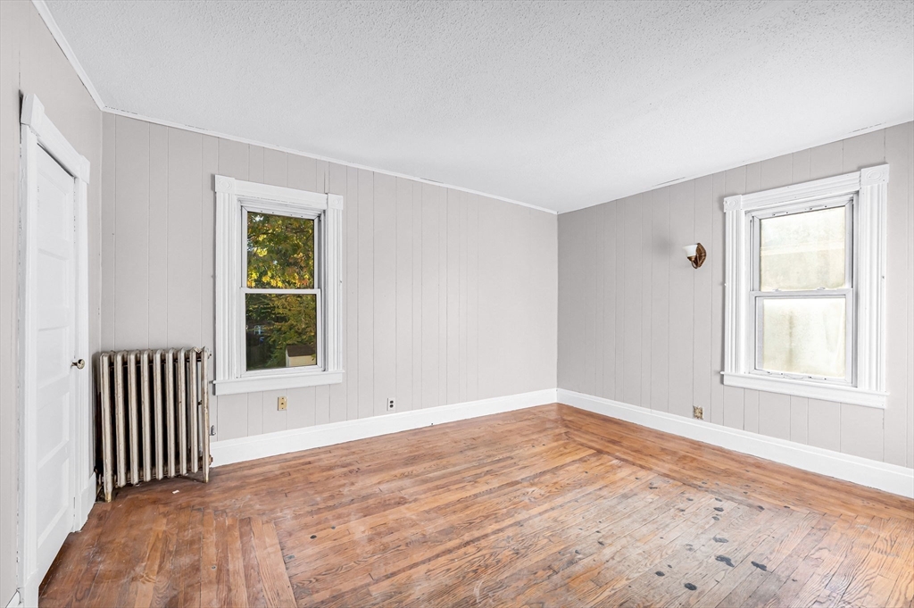 29 Wareham Street Springfield, MA 01108 - Photo 19 of 38 a view of an empty room with wooden floor and a window