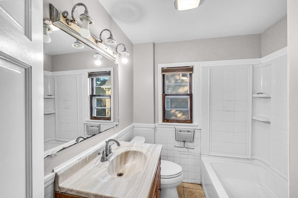 29 Wareham Street Springfield, MA 01108 - Photo 23 of 38 a bathroom with a sink toilet a mirror and bathtub