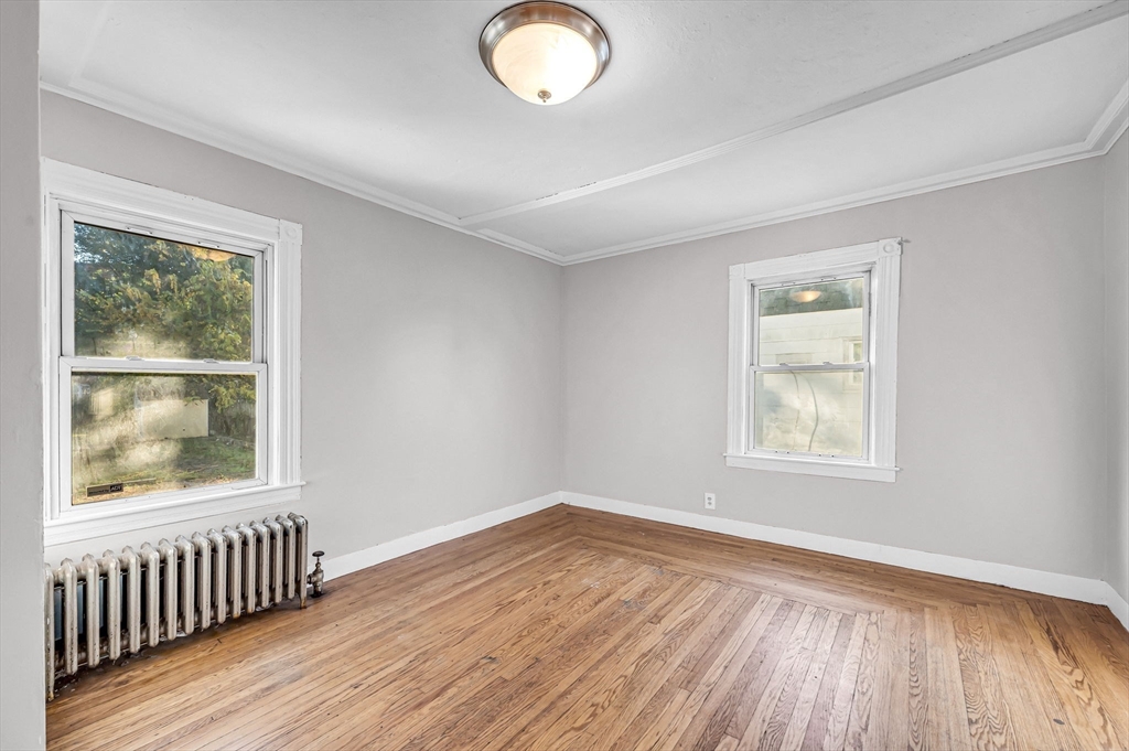 29 Wareham Street Springfield, MA 01108 - Photo 8 of 38 an empty room with wooden floor and windows