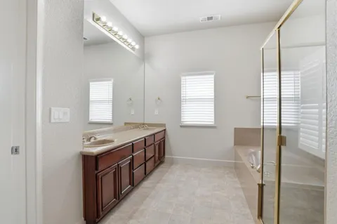 a bathroom with a bathtub and shower