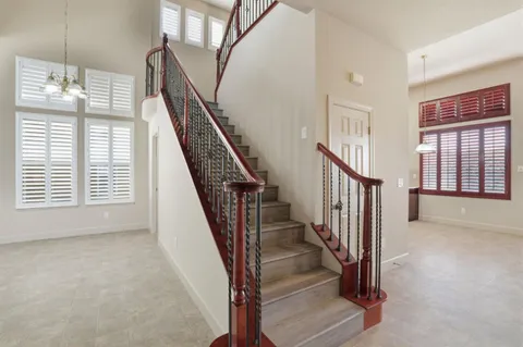 a view of hallway with furniture and wooden floor