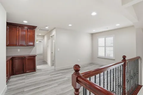 a view of a hallway with wooden floor