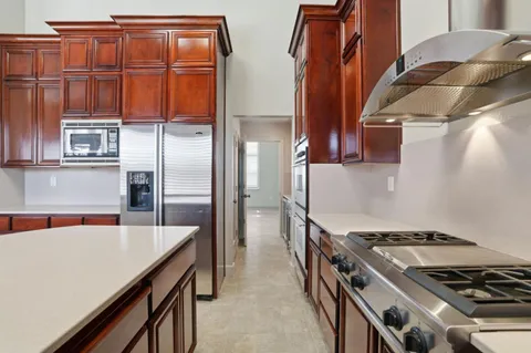 a kitchen with stainless steel appliances granite countertop a stove and a refrigerator