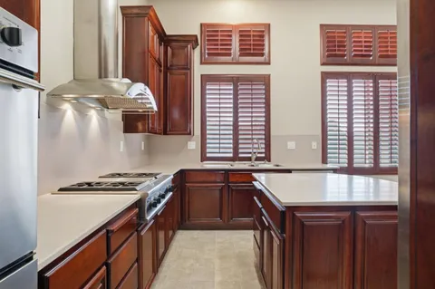 a kitchen with stainless steel appliances granite countertop a sink stove and cabinets