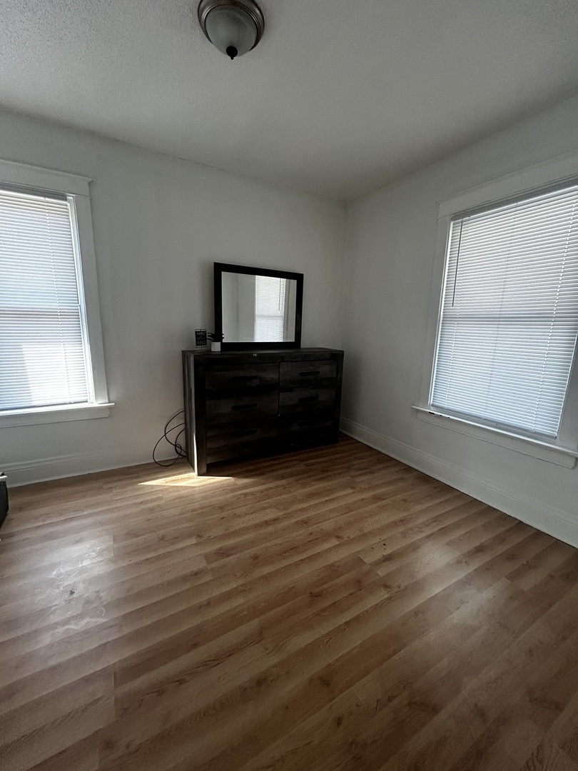 1041 West 104th Place Chicago, IL 60643 - Photo 13 of 19 wooden floor in an empty room with a window