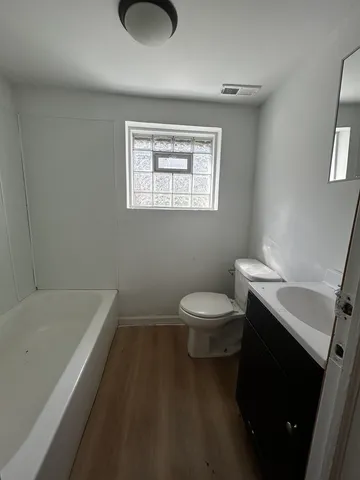 a bathroom with a toilet a sink and bathtub