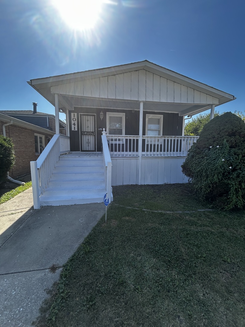 1041 West 104th Place Chicago, IL 60643 - Photo 3 of 19 a front view of a house with garden