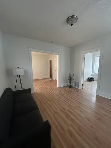 a empty room with wooden floor and furniture