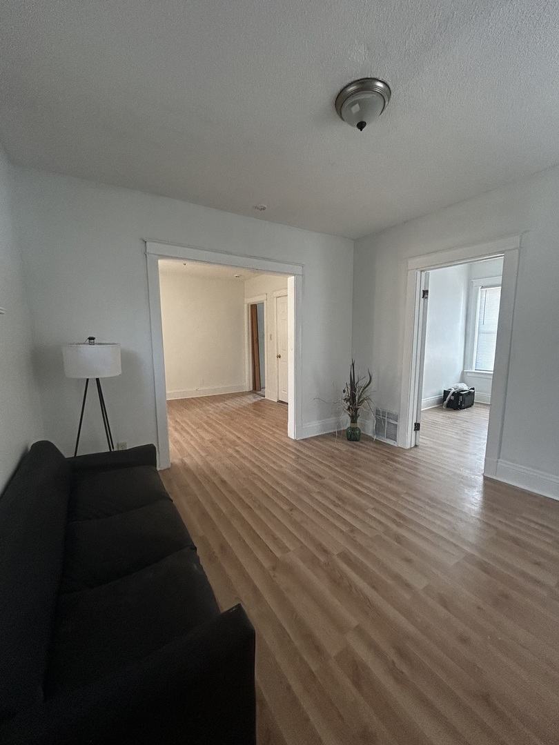 1041 West 104th Place Chicago, IL 60643 - Photo 10 of 19 a empty room with wooden floor and furniture