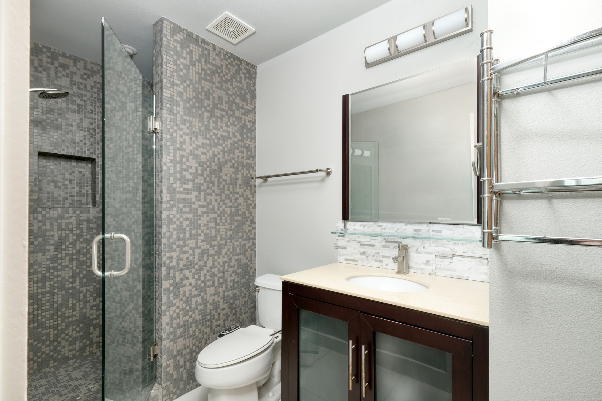 3000 Speedway Street, Unit E Austin, TX 78705 - Photo 7 of 16 Modern bathroom featuring a glass-enclosed shower and sleek vanity with integrated sink.