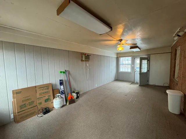 a view of a livingroom with furniture and a ceiling fan