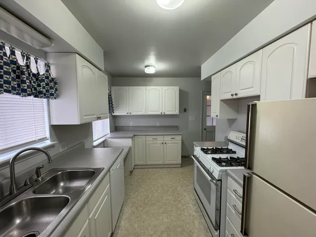 a kitchen with a sink stainless steel appliances and cabinets