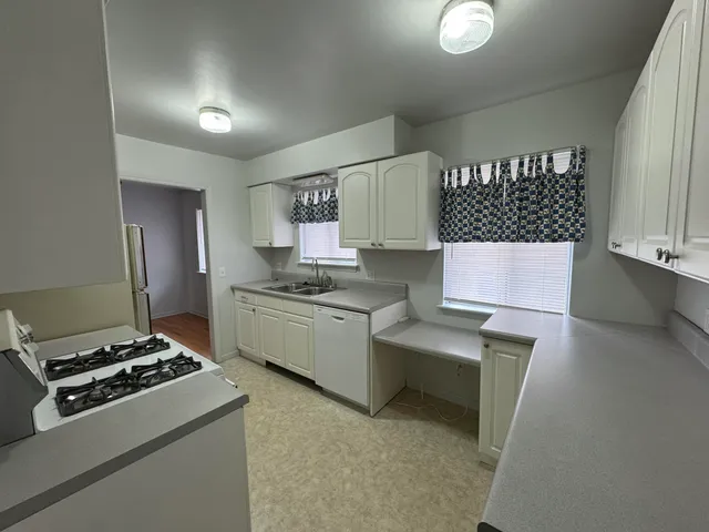 a kitchen that has a sink and a stove