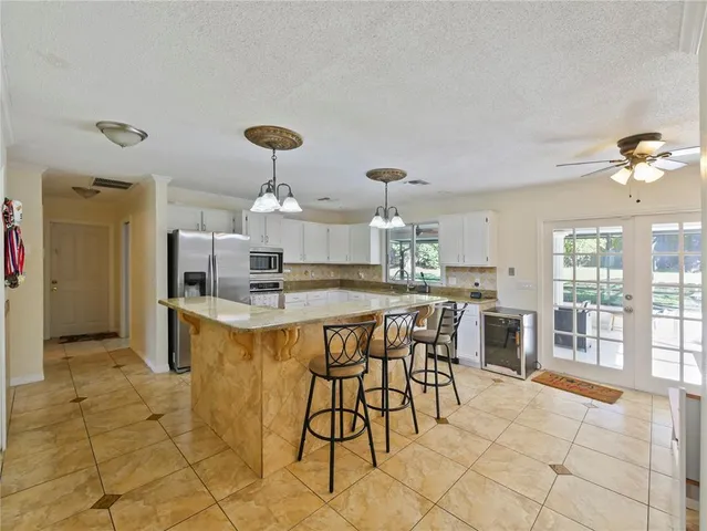 a large kitchen with a table and chairs