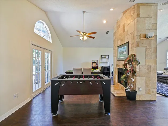 a kitchen with kitchen island granite countertop a sink counter top space appliances and cabinets