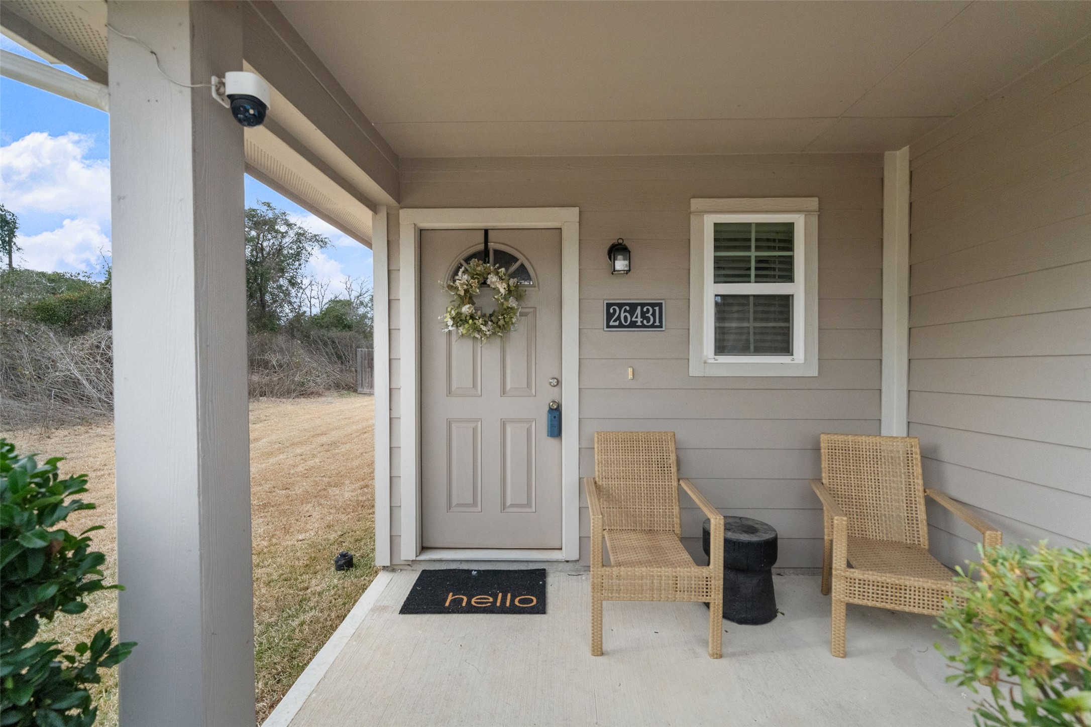 26431 Pin Oak Drive Hempstead, TX 77445 - Photo 6 of 32 Covered front porch with space for seating, creating a comfortable spot to relax outdoors. The entry features a classic front door and charming curbside details.