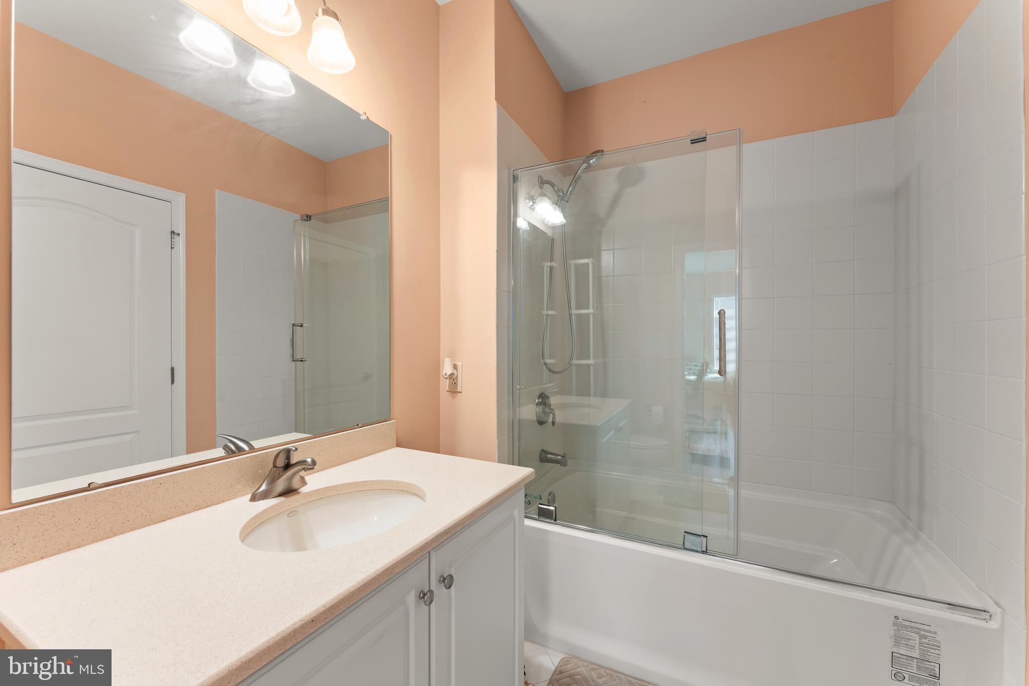 516 Carson Terrace Huntingdon Valley, PA 19006 - Photo 13 of 29 a bathroom with a bathtub shower sink vanity and mirror